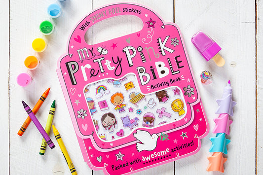 My Pretty Pink Bible Activity Children's  book on a wooden surface with crayons and stickers.