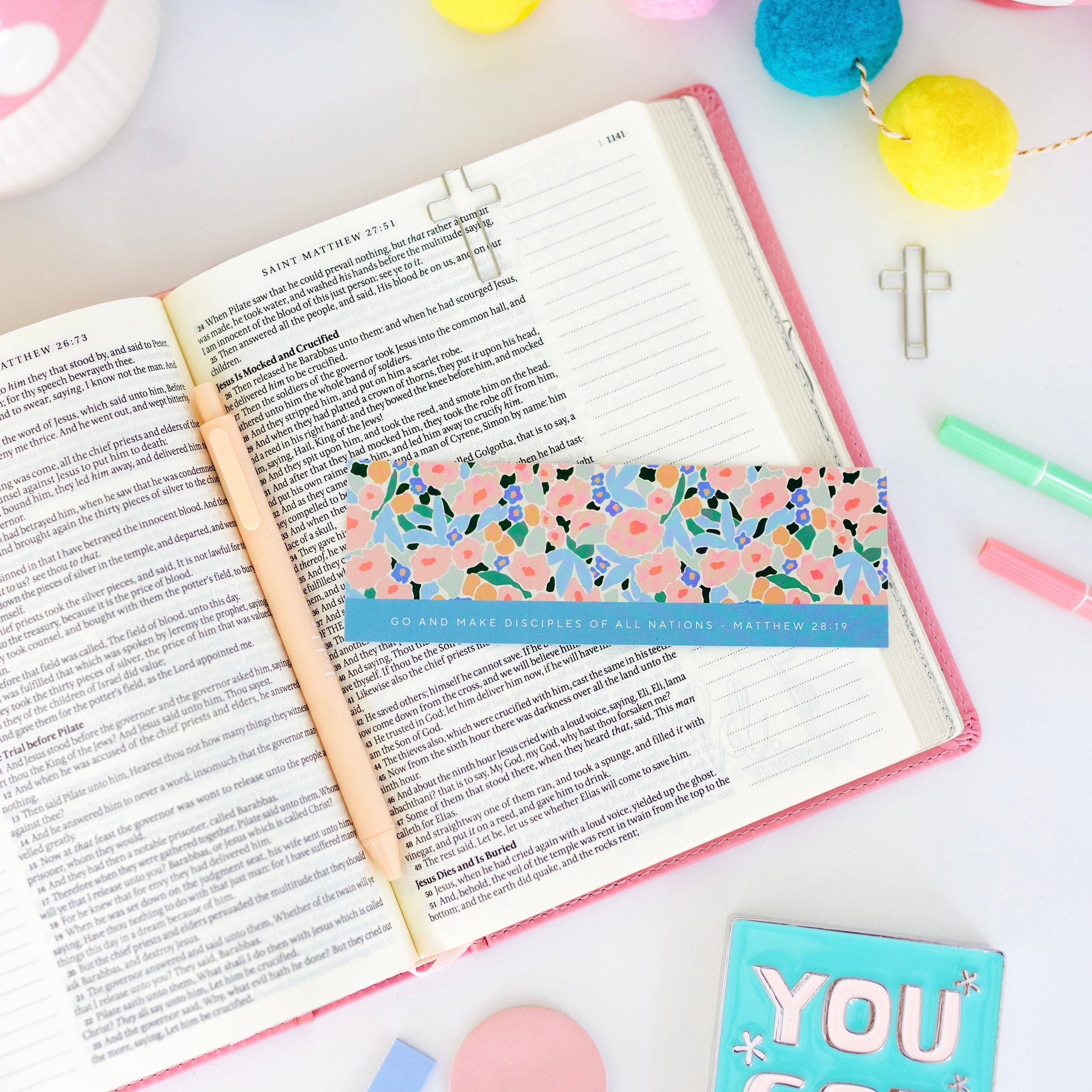 Open book with a floral bookmark on a colorful background