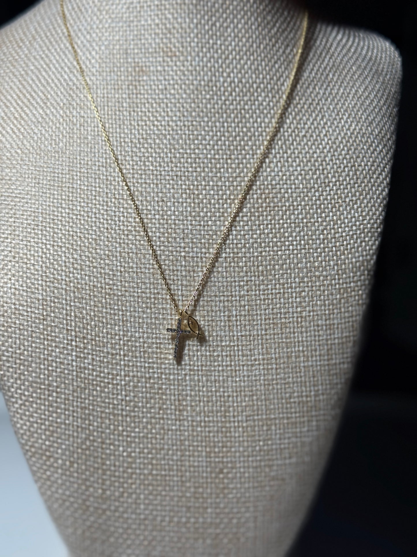Necklace with a pendant on a mannequin bust against a dark background