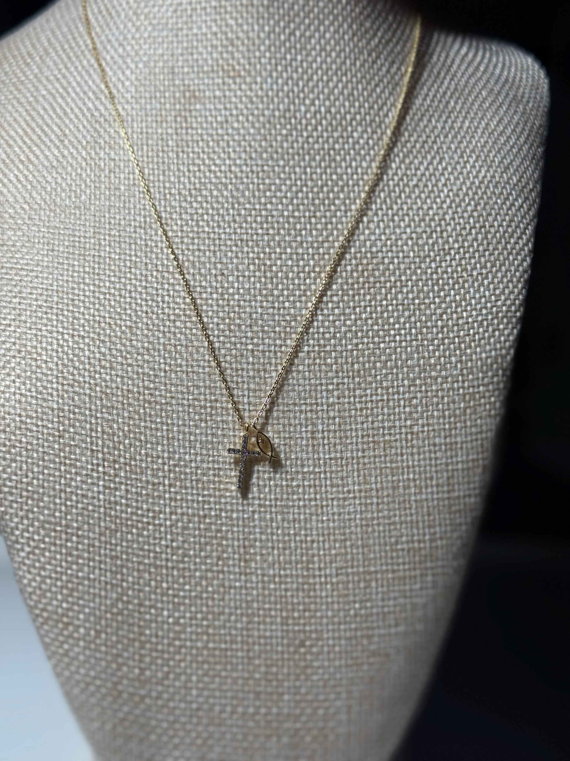 Necklace with a pendant on a mannequin bust against a dark background