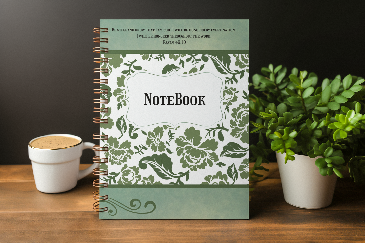 Notebook with floral design on a wooden surface with a cup and plant
