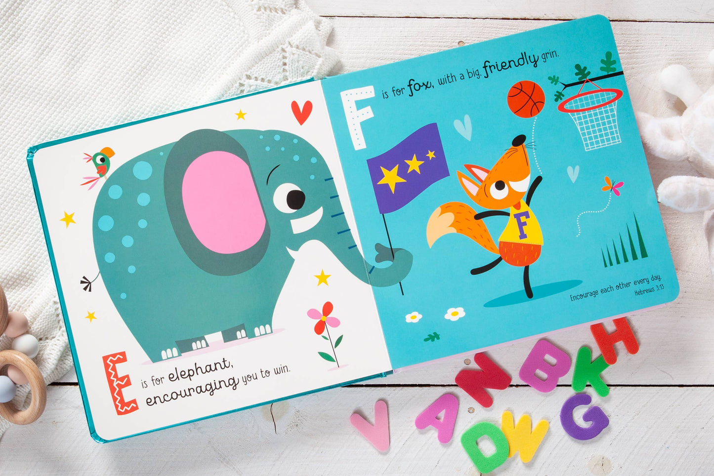 Children's book with an elephant and a fox illustration on a wooden surface.