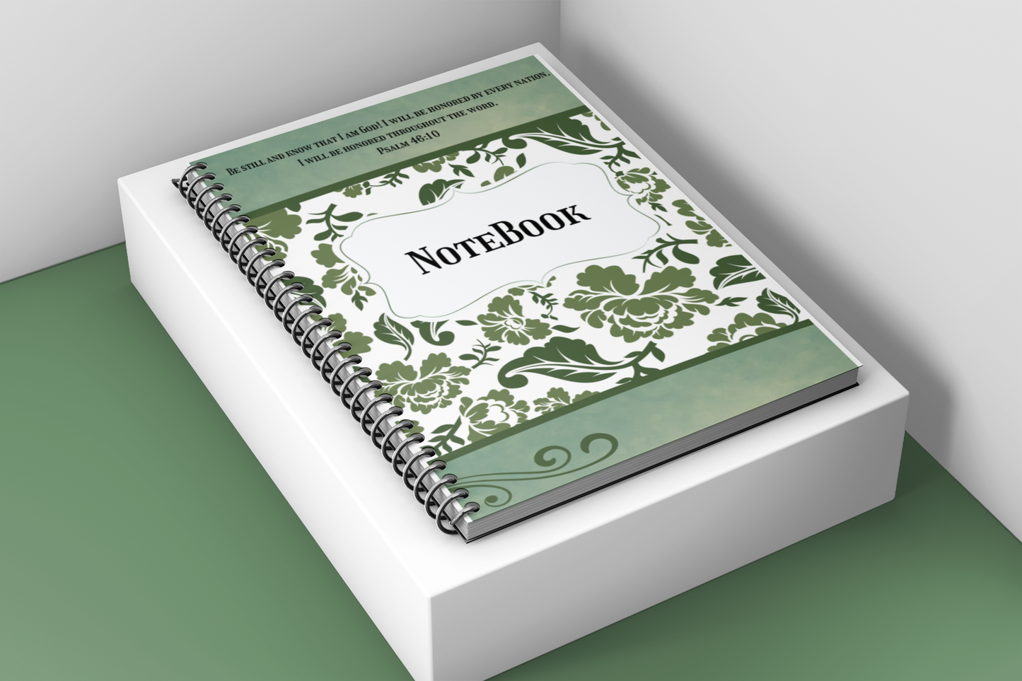 Notebook with green floral design on a white surface