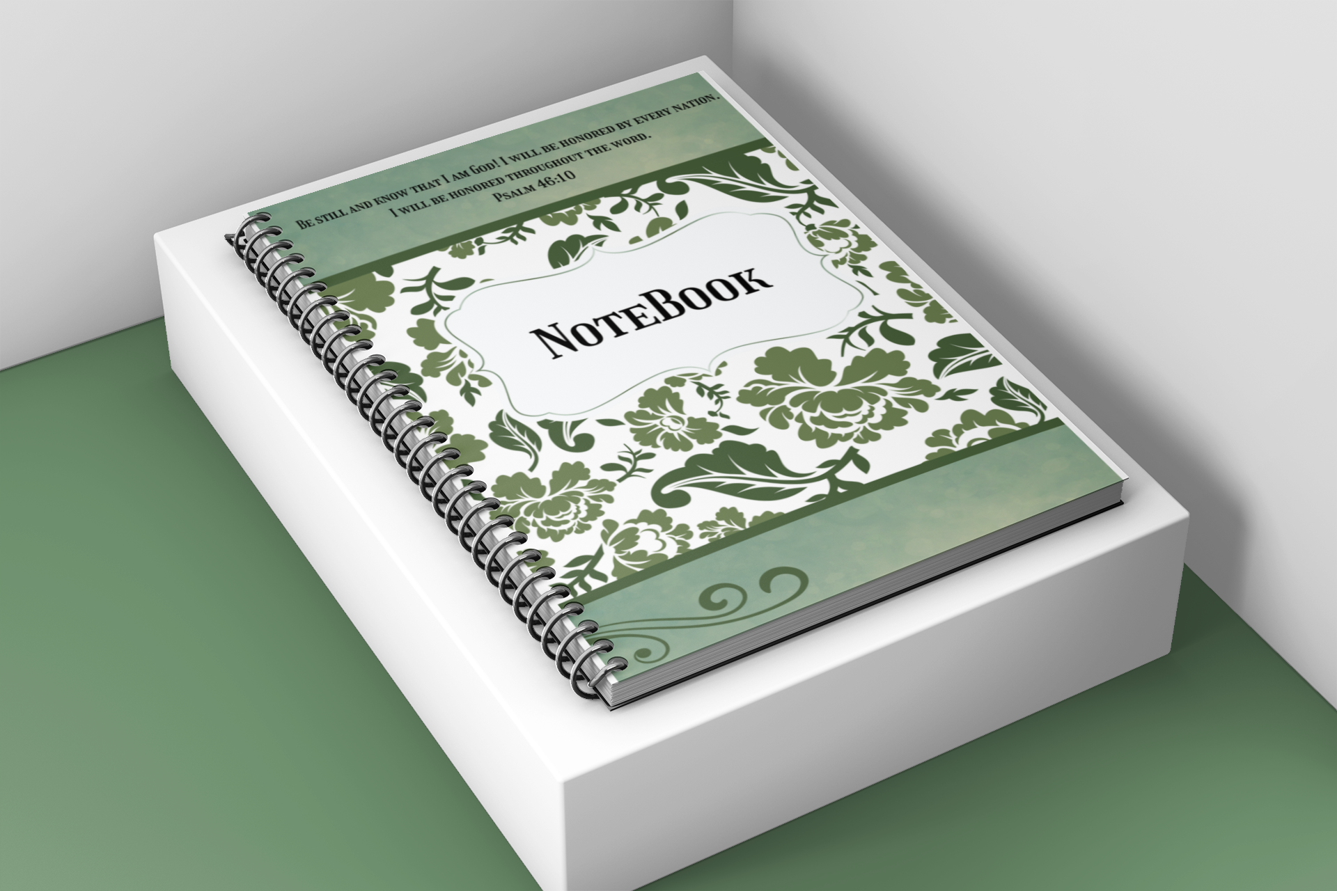 Notebook with green floral design on a white surface