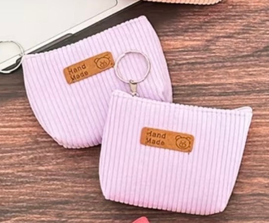 two Corduroy light purple coin purses with attached keyring and zipper closure.
