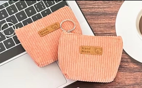 Two Corduroy peach coin purse with attached keyring and zipper closure.