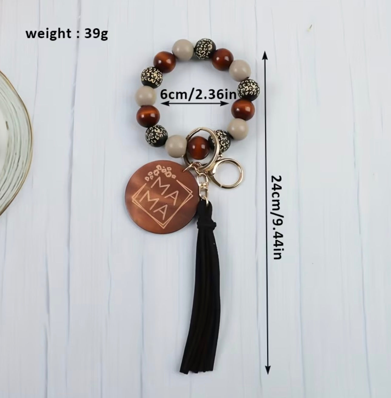 Beaded keychain with lepard
 wooden pendant and tassel on a white background