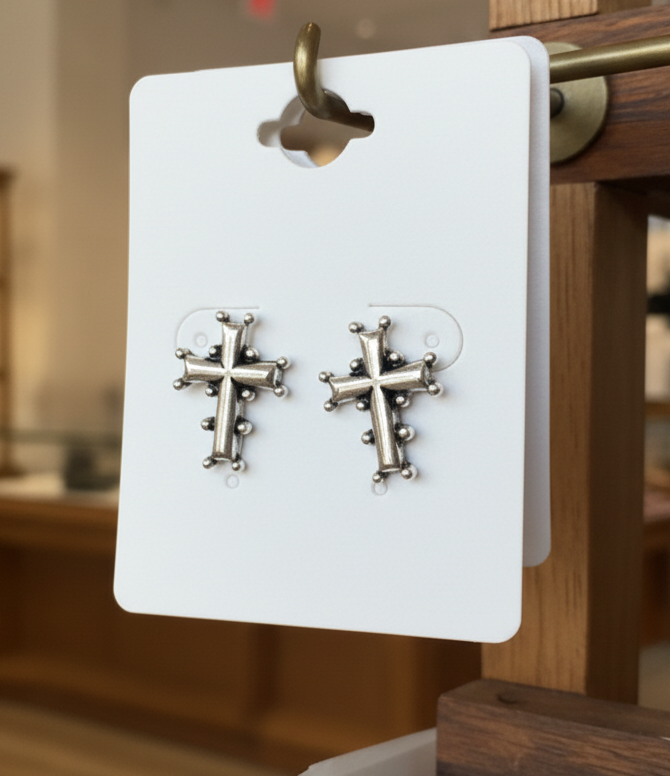 "Silver-Toned Cross Earrings with Embellishments."