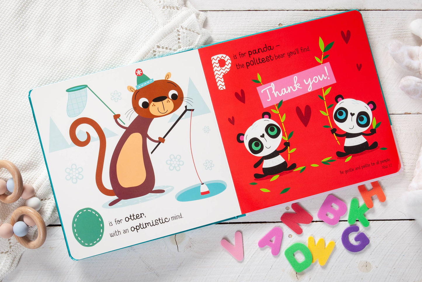 Children's book with a squirrel illustration and a panda-themed page on a white surface.